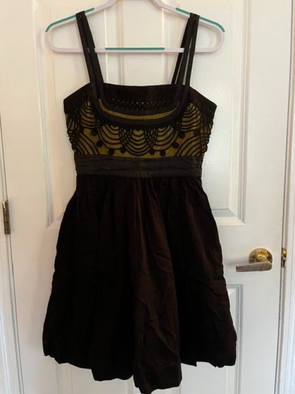 Black dress with golden bodice and black lace overlay.